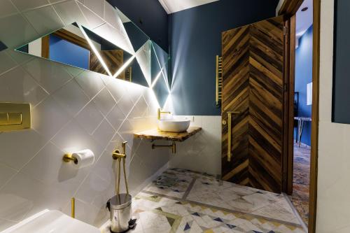 a bathroom with a sink and a wooden door at Mtserlebi Resort in K'vishkhet'i