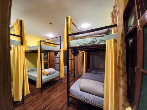 a room with two bunk beds with a tv at John's Homestay in Srinagar