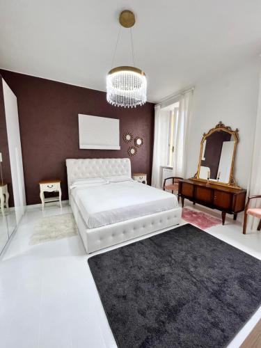 a bedroom with a large white bed and a mirror at Splendid Lake 3 in Desenzano del Garda