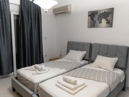 two beds sitting next to each other in a room at MG Villa Rhodes in Kalithies