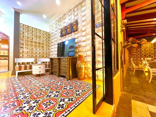 a living room with a rug on the floor at Bhumi Sammy by Sammy Home Yogyakarta in Timuran