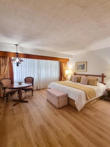 a large bedroom with a large bed and a table at Antara Hotel & Suites - Miraflores in Lima