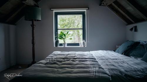 Tempat tidur dalam kamar di Het Ovenhuisje