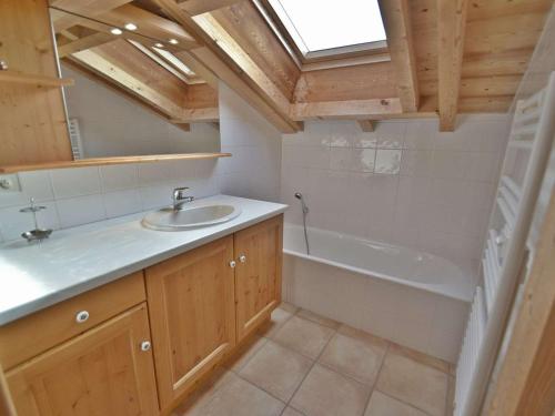 a bathroom with a sink and a bath tub at Chalet Le Grand-Bornand, 7 pièces, 10 personnes - FR-1-391-19 in Le Grand-Bornand