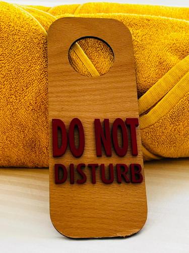 a sign that says do not disturb with a banana at Fogo Boutique Hotel in São Filipe