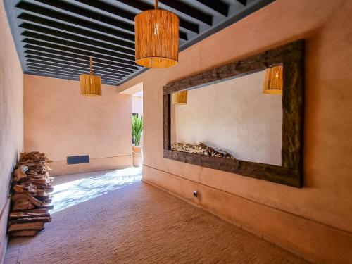 a living room with a large mirror on the wall at Villa avec gouvernante et 2 piscines dont une chauffée dans domaine securise in Marrakesh