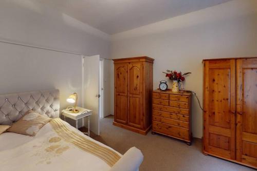 a bedroom with a bed and a dresser and a drawer at Spacious one bedroom flat in West Hoathley