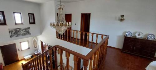 a room with a staircase and a chandelier at Vivenda Alju in Ourém