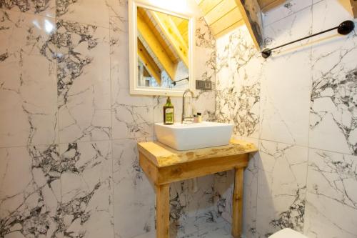 a bathroom with a sink and a mirror at Kidrak Hotel in Faralya