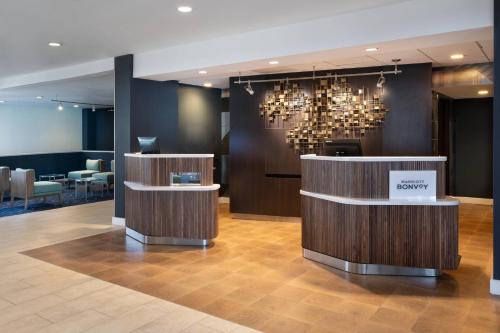 a lobby with a waiting area with a chandelier at Courtyard by Marriott West Palm Beach in West Palm Beach