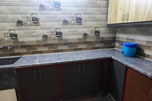 a kitchen with a sink and a counter top at Tejovrishananda Luxury Stays in Tirupati