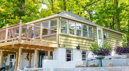 a house with a large deck on top of it at Paradise Cottage C2 in Greenville