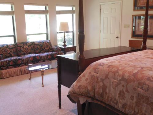 a living room with a bed and a couch at Dogwood Springs Lodgings in Mineola