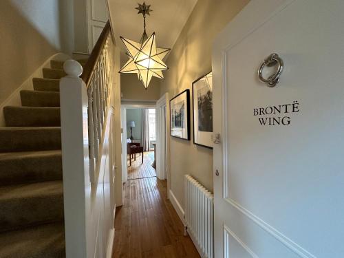 a hallway with a staircase with a star on the wall at The Brontë Wing at The Apothecary Rye in Rye