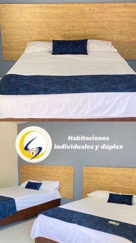 2 camas con sábanas azules y blancas en una habitación en Hotel Luna Sanjuanera, en San Juan del Cesar