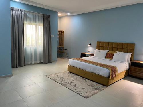 a bedroom with a large bed and a window at Breezes Beach Resort 