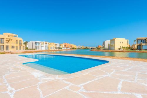a swimming pool in a resort with buildings in the background at Apartment in Gouna Tawila The Butterfly in Hurghada