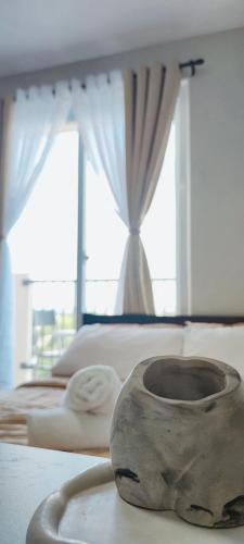 a room with two beds and a vase on a table at Z's Place in Suba