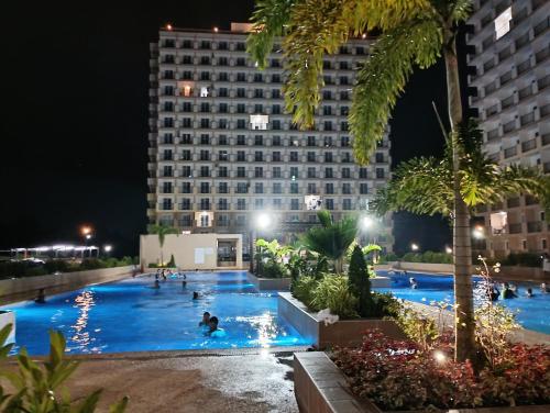 a pool at night with people swimming in it at Z's Place in Suba
