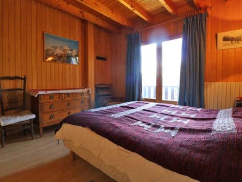 a bedroom with a bed and a dresser and a window at Chalet Montvalezan-La Rosière, 9 pièces, 18 personnes - FR-1-398-582 in Montvalezan