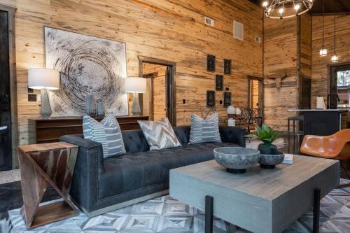 a living room with a couch and a table at The Blaylock Cabin, 2 King, Hot Tub, Pet Friendly! in Broken Bow