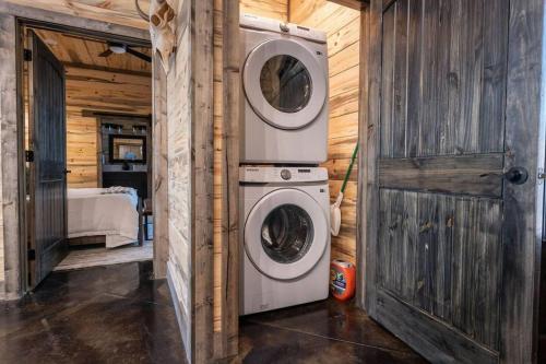 a laundry room with a washer and dryer in a house at The Blaylock Cabin, 2 King, Hot Tub, Pet Friendly! in Broken Bow
