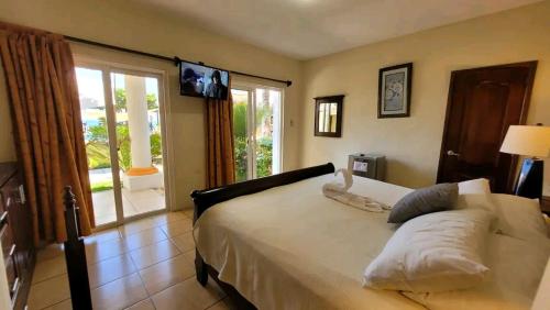 a bedroom with a large bed with a large window at Hotel Hawaian Paradise in Hawaii