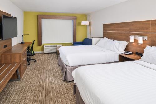 a hotel room with two beds and a flat screen tv at Holiday Inn Express & Suites - Ogallala by IHG in Ogallala