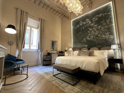 a bedroom with a large painting on the wall at Casa del Fauno in Montepulciano