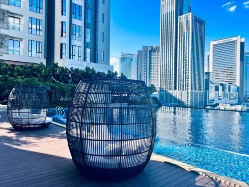 a bird cage sitting next to a body of water at Sentral Serviced Suites Kuala Lumpur in Kuala Lumpur