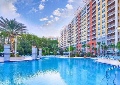 a large swimming pool in front of a building at VACATION VILLAGE PARKWAY - KISSIMMEE,FL 34747 in Orlando