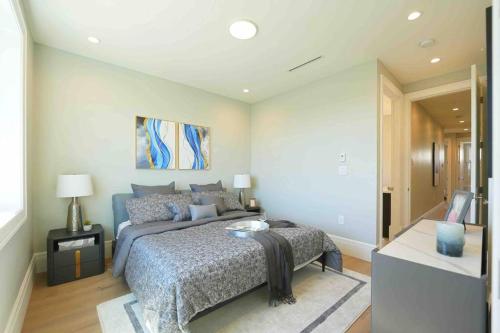 a bedroom with a bed and a television in it at Four bedrooms New Lovely Duplex -1626 in Vancouver