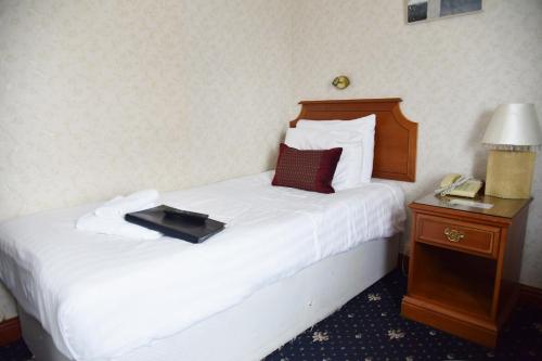 a hotel room with a bed with a tray on it at Crystal Hotel & Savour in Cambridge
