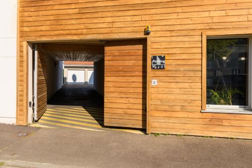 a wooden building with a door leading to a hallway at Hype Hôtel in Biscarrosse