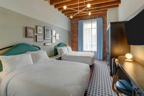 a hotel room with two beds and a window at Trilogy Hotel Montgomery, Autograph Collection in Montgomery