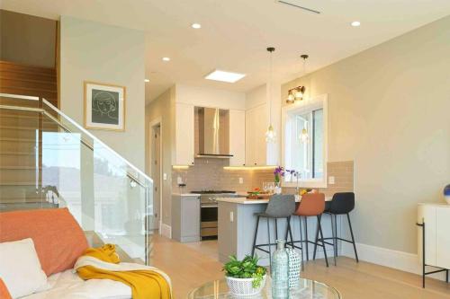 a living room and kitchen with a couch and a table at Four bedrooms New Lovely Duplex House-1628 in Vancouver