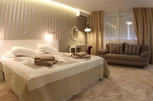 a bedroom with a large bed with towels on it at Studio Apartments Mirakul in Split
