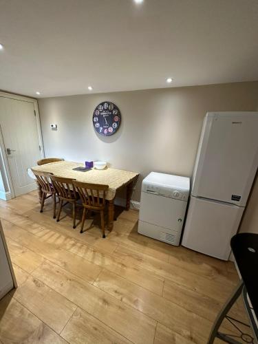 a dining room with a table and a refrigerator at RIVERSIDE APARTMENT IN THE CENTRE in Boston