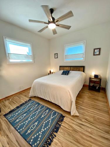 a bedroom with a bed and a ceiling fan at Giriraja Ashraya in Moundsville