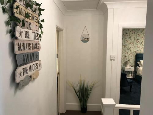 a room with a hallway with signs on the wall at Dolphin Retreat close to Beaches and Harbour in Poole