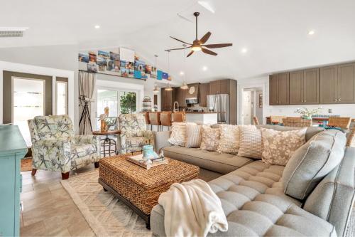 a living room with a large couch and chairs at Awesome Location with Dock, Pool, Bicycles & Kayaks in Cape Coral