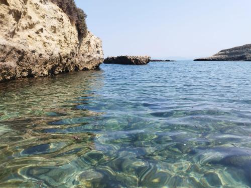 a view of the water near a rocky shore at b&b Casa Balai 72 a 100 mt dal mare in Porto Torres