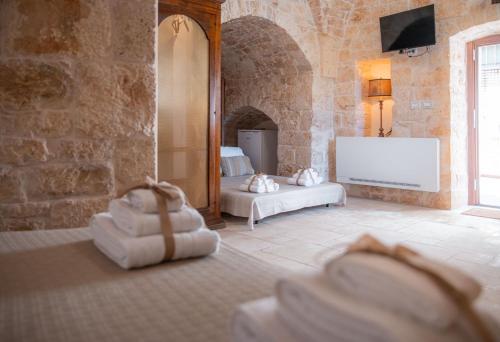 a living room with two beds and a mirror at Le Casette in Gravina Luxury in Villa Castelli