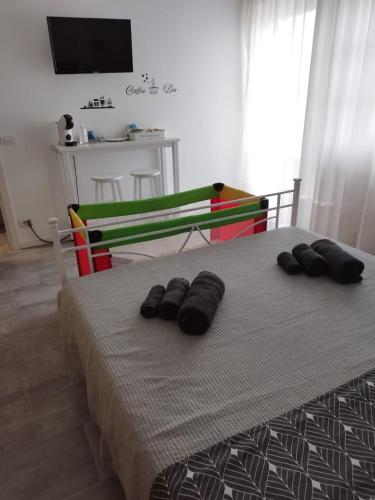 a bedroom with a bed with two pairs of shoes on it at b&b Casa Balai 72 a 100 mt dal mare in Porto Torres