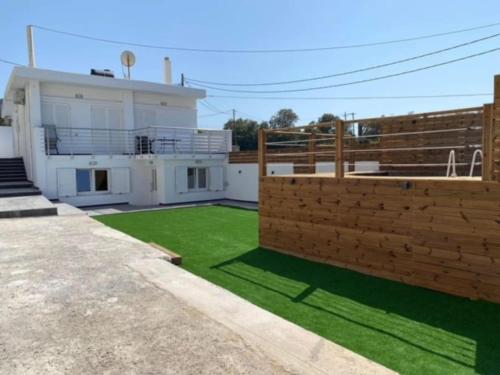 a house with a green lawn in front of it at Maria-Irini Villa in Gournes