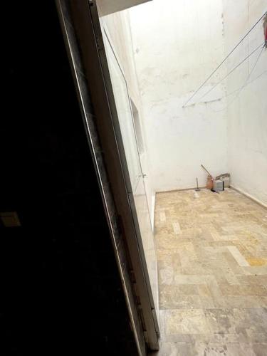 an empty room with a window and a tiled floor at Bel appartement 6 min de plage in Agadir