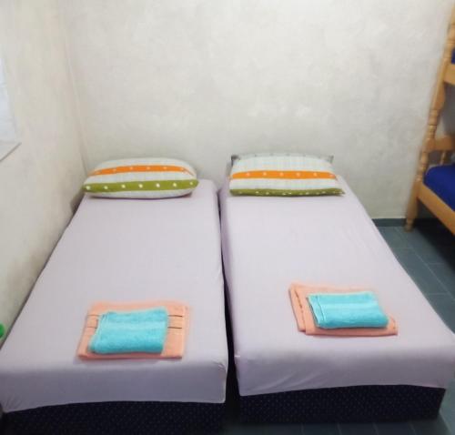 two beds sitting next to each other in a room at Terasse by the sea in Sutomore