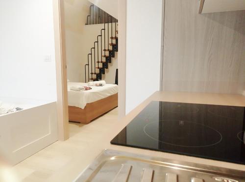 a kitchen with a view of a room with a bed at STRADONE 132 in Gravina in Puglia