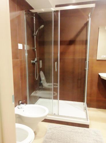a bathroom with a shower with a toilet and a sink at STRADONE 132 in Gravina in Puglia