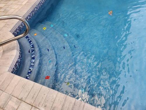 a swimming pool with people in the water at Welcome to the Dolphin Den! in Largo